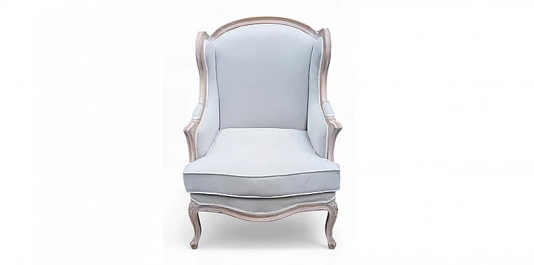 Κλασική πολυθρόνα με ντεκαπέ σκελετό από ξύλο οξιάς και βελούδινη ταπετσαρία στο χρώμα του πάγου, με ψηλή πλάτη και καμπύλες γραμμές.